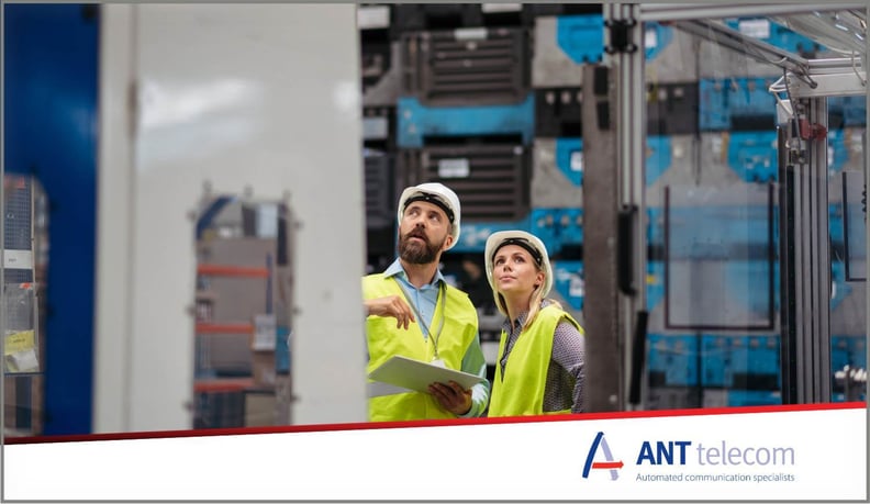 Engineers communicating across a manufacturing site face to face.