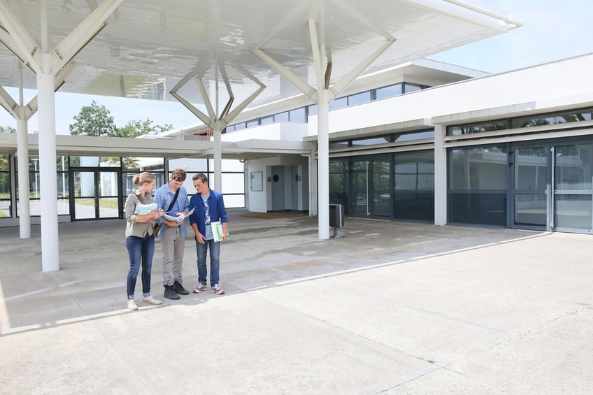 Group of students standing by school building.jpeg