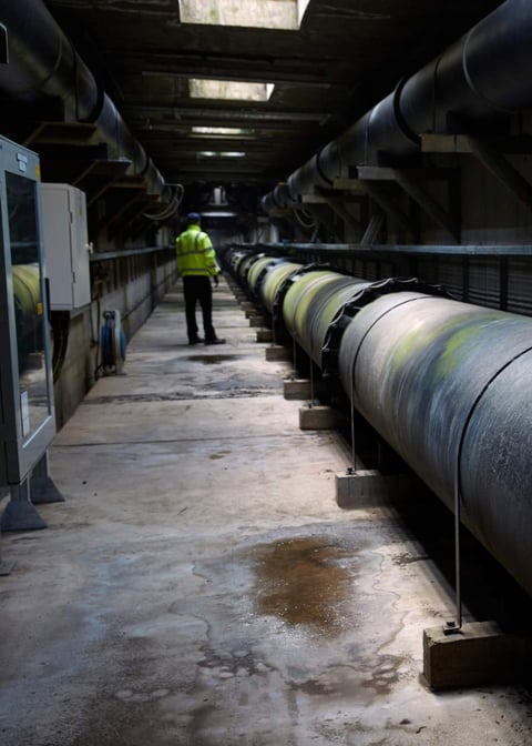 A lone worker in an underground water treatment area