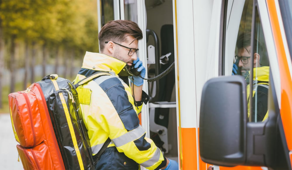 ambulance worker talking on radio