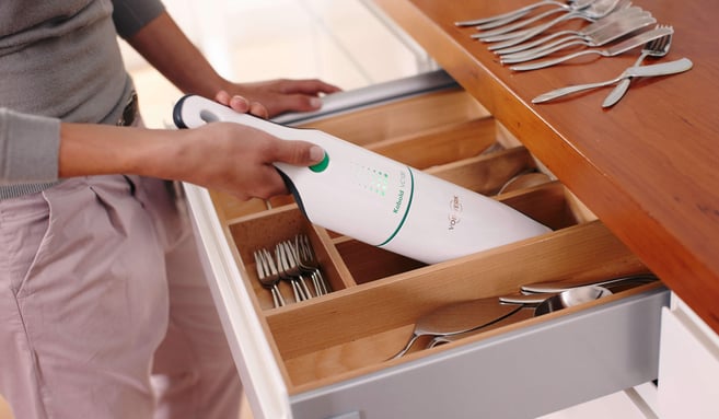 man using a Vorwerk cleaning device