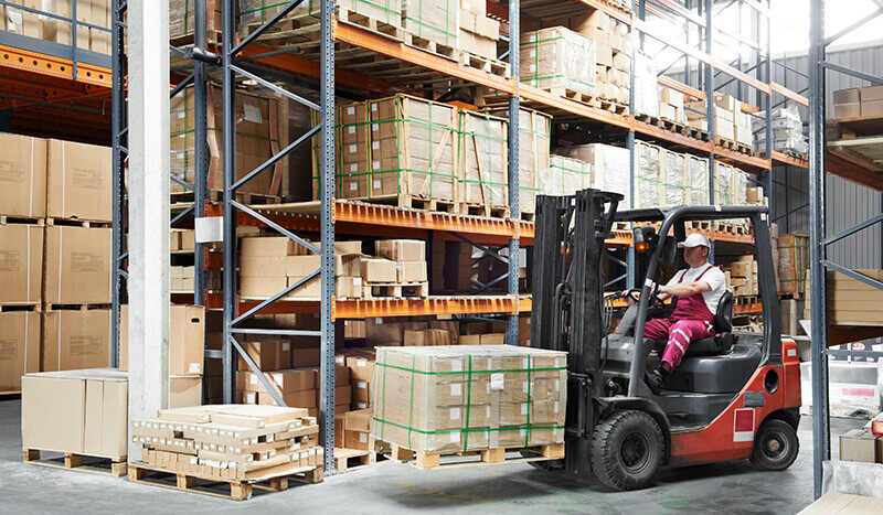 warehouse worker using a pallet lift truck