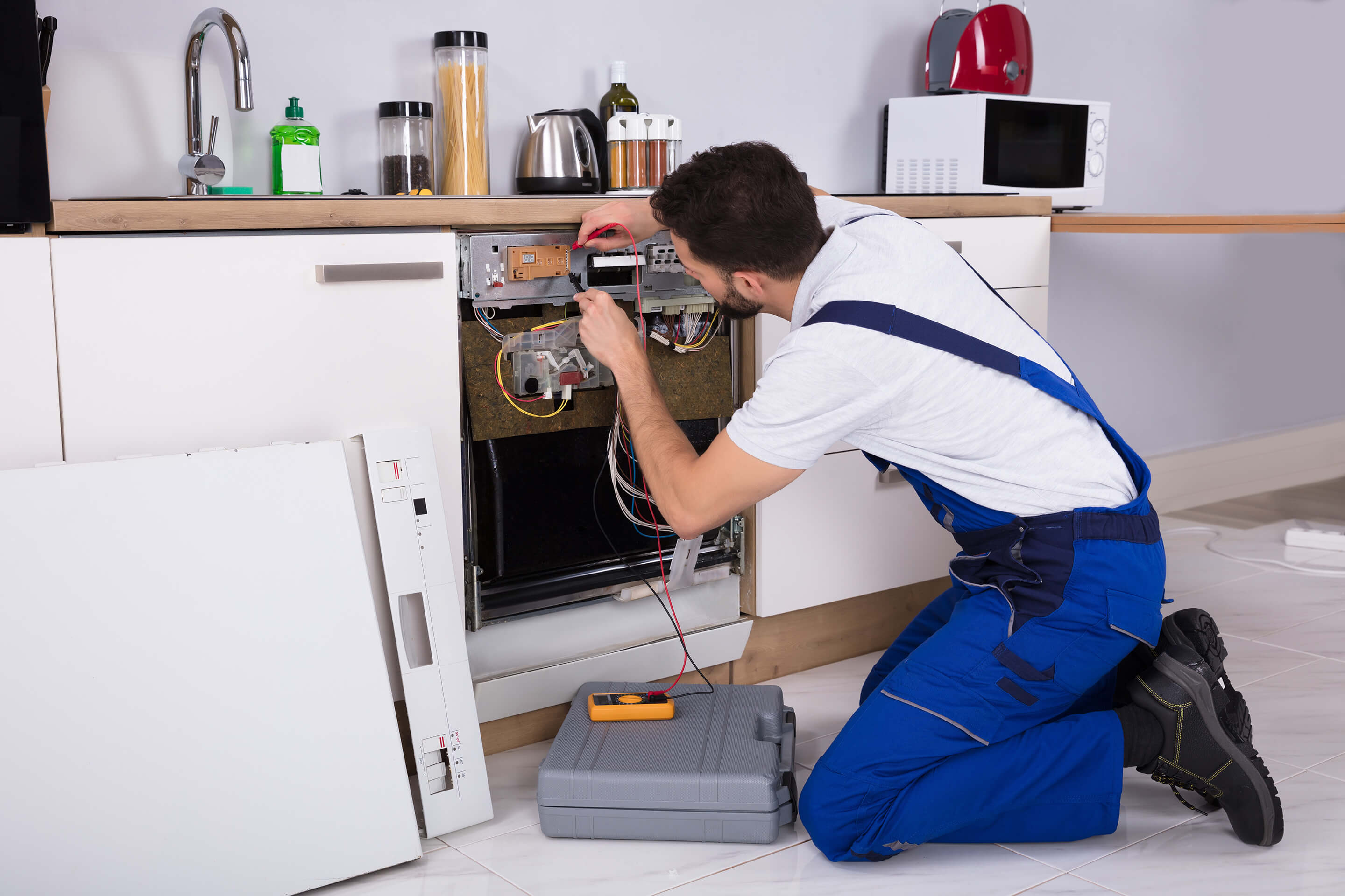 workman fixing a dishwasher